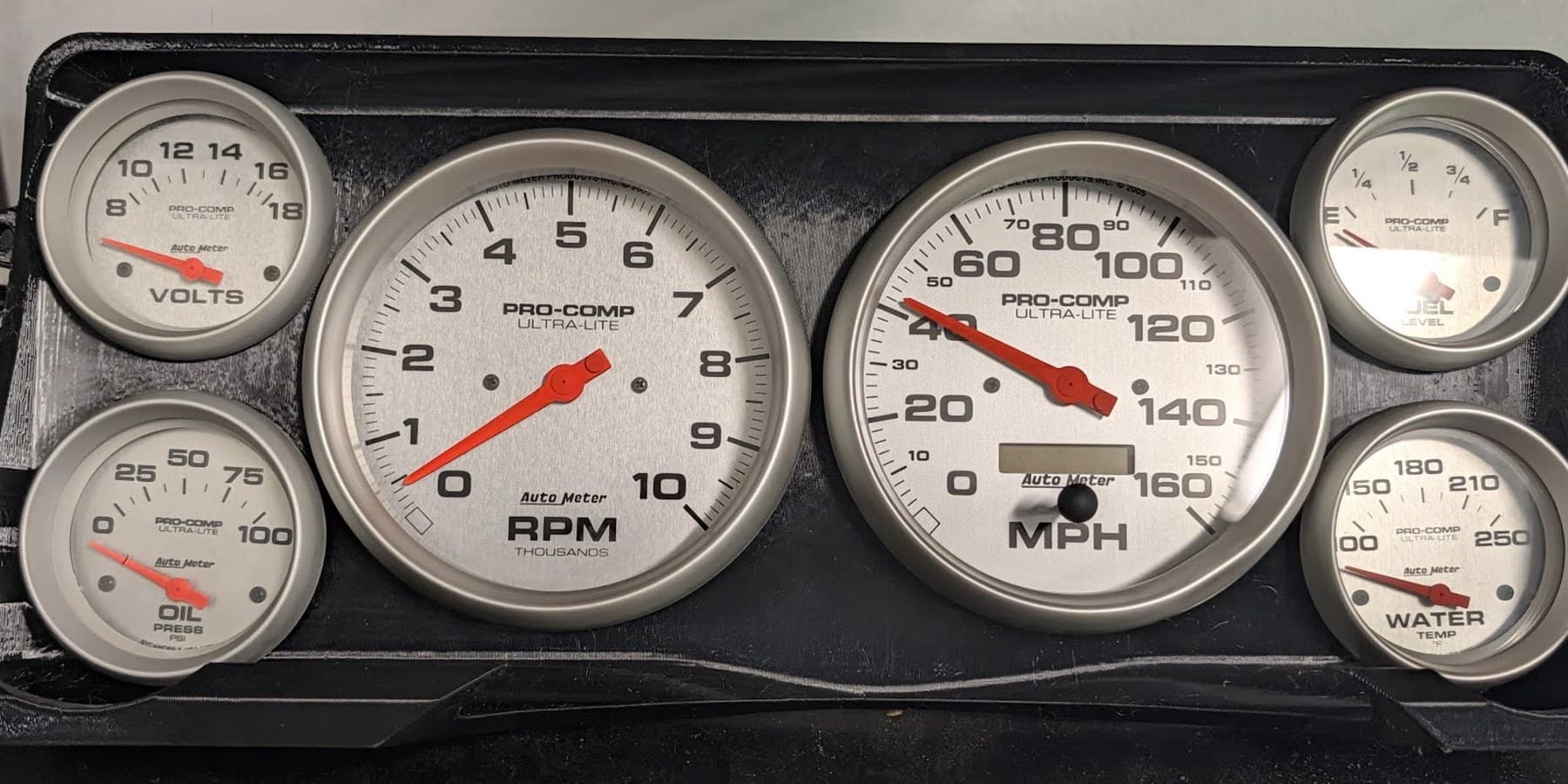 Printed OBS cluster insert fitted with a set of Autometer Ultra-Lite gauges